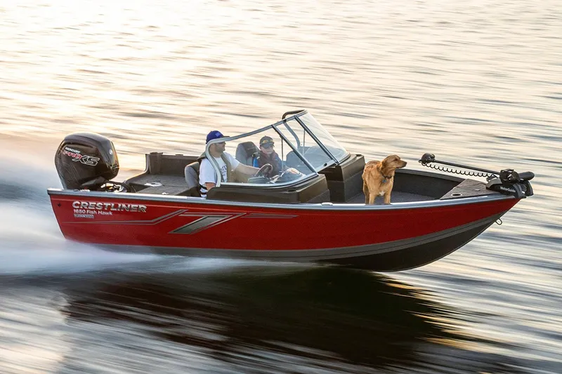 Slide: The Image of Manufacturer Provided Image: 2019 Crestliner 1650 Fish Hawk WT JS boat speeding on water with two people and a dog. - 8
