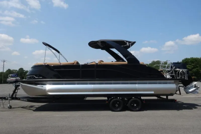 The Image of 2026 Harris Grand Mariner 250 pontoon boat on trailer under clear blue sky. - 1