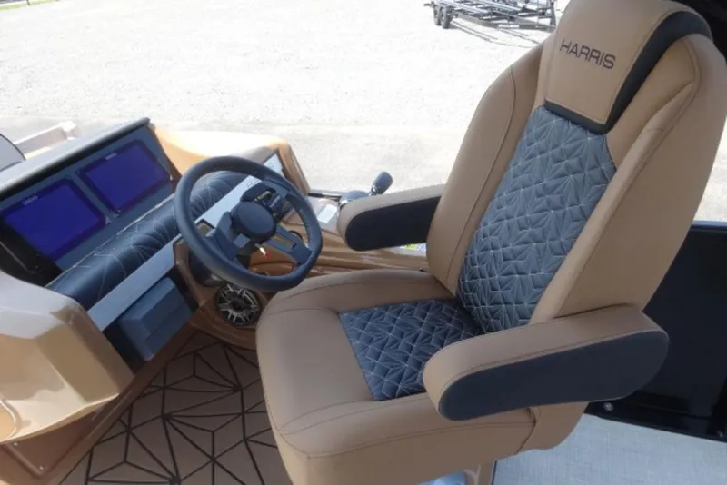 Slide: The Image of Captain's chair and dashboard of 2026 Harris Grand Mariner 250 boat, featuring modern design. - 12