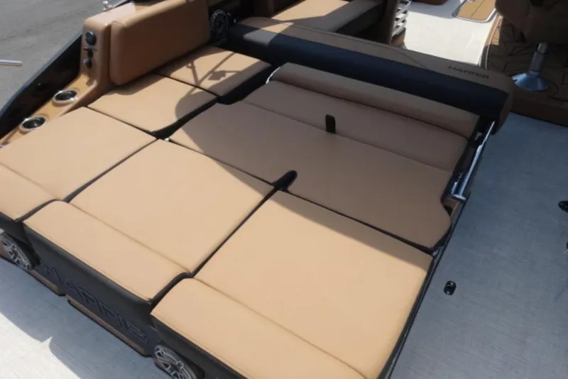 Slide: The Image of 2026 Harris Grand Mariner 250 boat with tan cushioned seating area. - 15