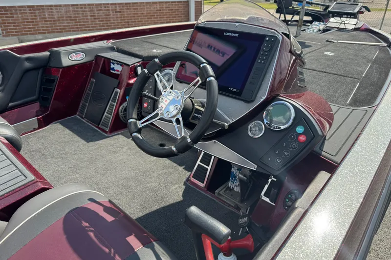 Slide: The Image of 2014 Ranger Z521 Comanche boat cockpit with steering wheel and navigation system. - 12