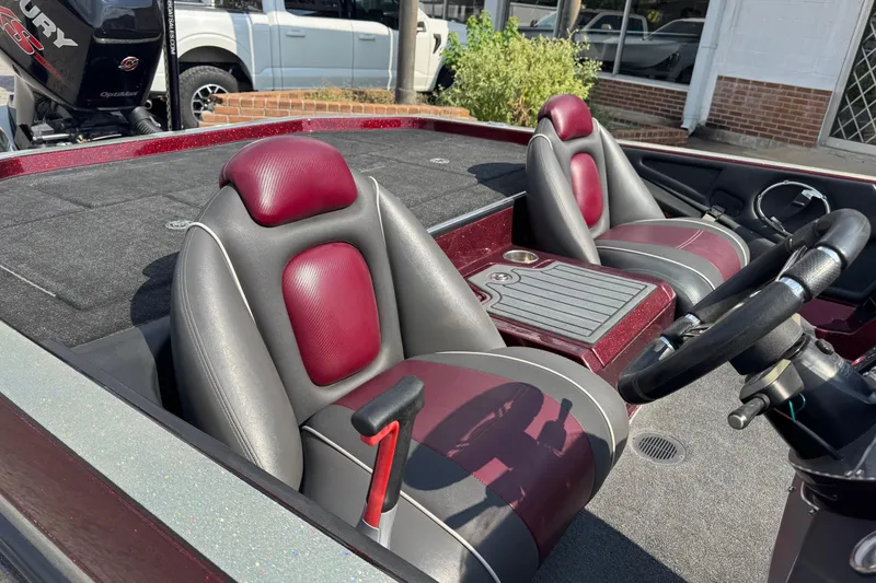 Slide: The Image of 2014 Ranger Z521 Comanche boat interior with maroon and gray seats, steering wheel, and console. - 13
