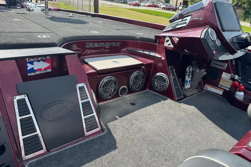 Slide: The Image of 2014 Ranger Z521 Comanche boat interior with dashboard and storage compartments. - 14