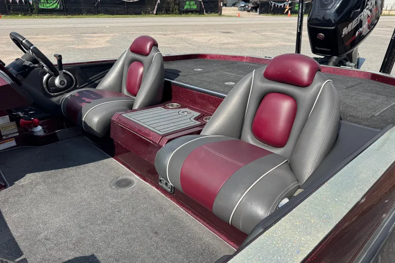Slide: The Image of 2014 Ranger Z521 Comanche boat interior with maroon and gray seats. - 15
