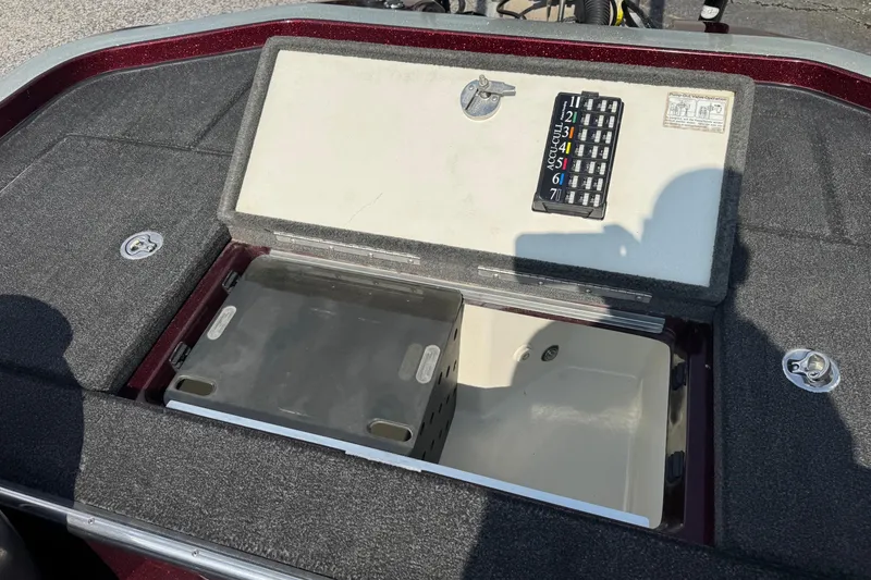 Slide: The Image of 2014 Ranger Z521 Comanche boat storage compartment with open lid and control panel. - 16