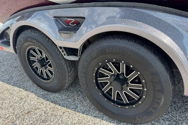 Slide: The Image of 2014 Ranger Z521 Comanche trailer with dual black alloy wheels on a textured surface. - 19