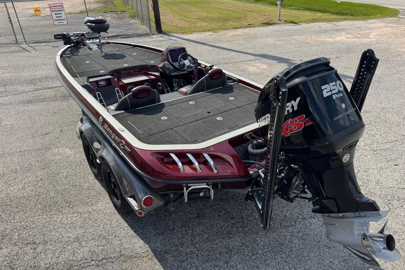 Slide: The Image of 2014 Ranger Z521 Comanche boat with Mercury 250 Pro XS engine, parked on pavement. - 2