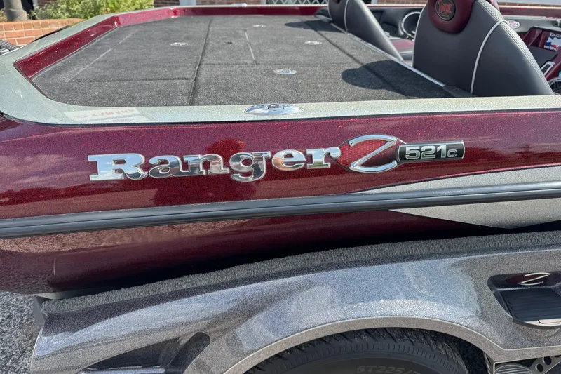 Slide: The Image of 2014 Ranger Z521 Comanche boat, maroon and gray, close-up of logo and seating area. - 6