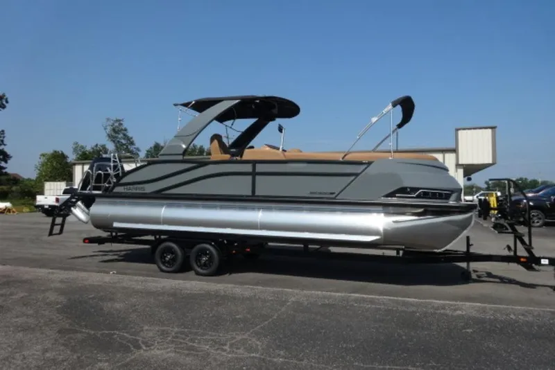 The Image of 2026 Harris Grand Mariner 250 pontoon boat on trailer, parked outdoors. - 1