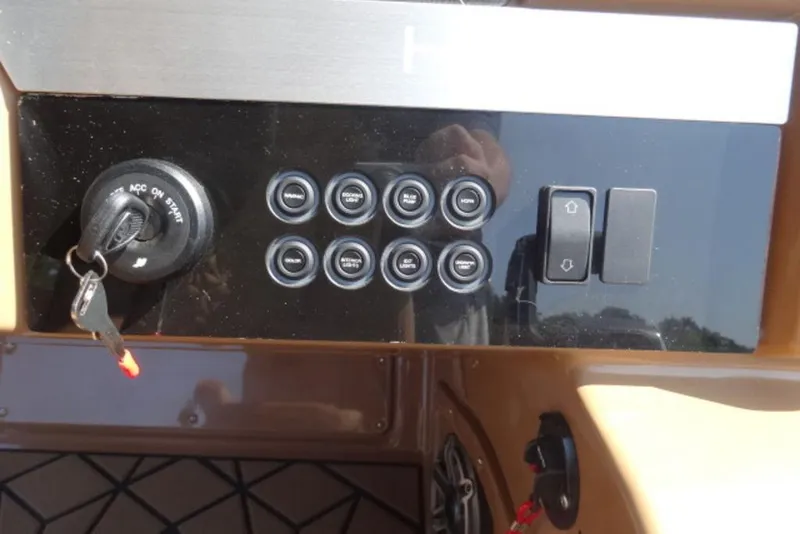 Slide: The Image of Control panel of 2026 Harris Grand Mariner 250 boat with ignition and switches. - 6