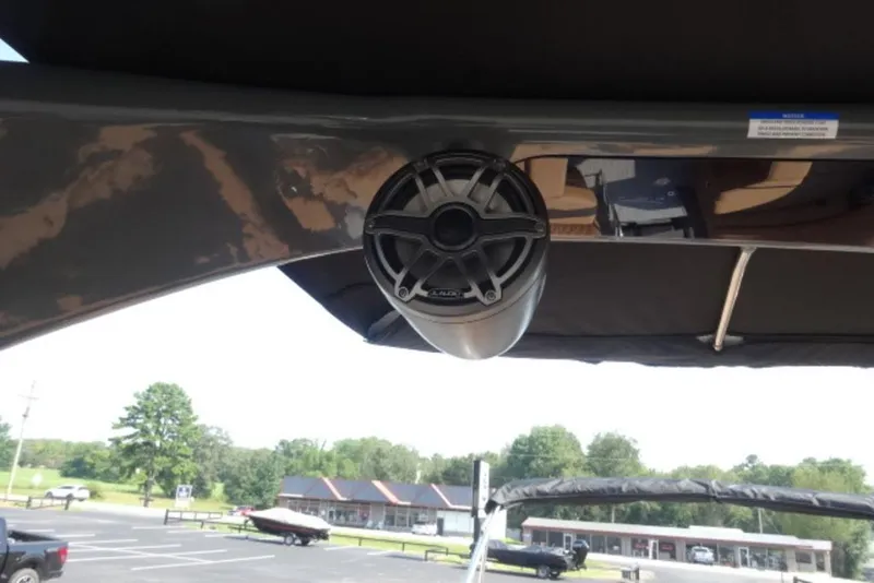 Slide: The Image of Speaker mounted on a 2026 Harris Grand Mariner 250 boat, with a scenic background. - 8