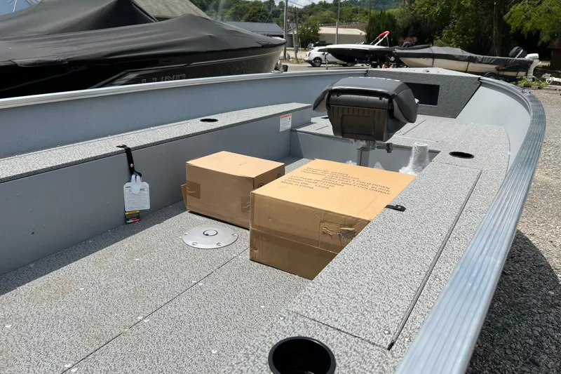Slide: The Image of 2026 Lund 1600 Fury Tiller boat interior with boxes and seating. - 7