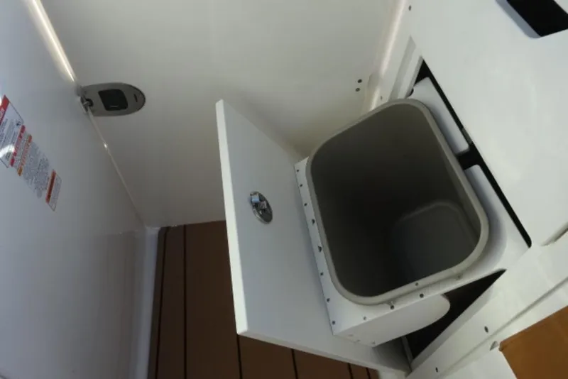 Slide: The Image of 2026 Chaparral 30 Surf boat interior storage compartment with open lid. - 18