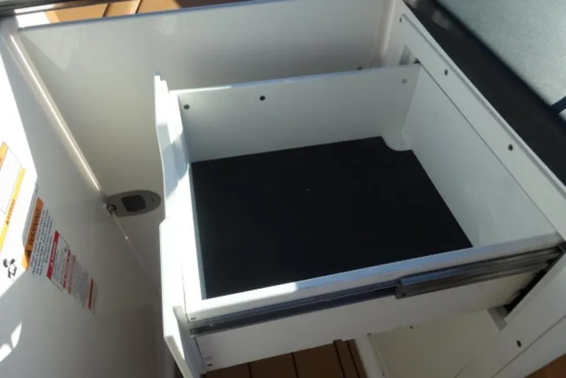 Slide: The Image of Storage compartment in 2026 Chaparral 30 Surf boat, featuring sleek design and ample space. - 19