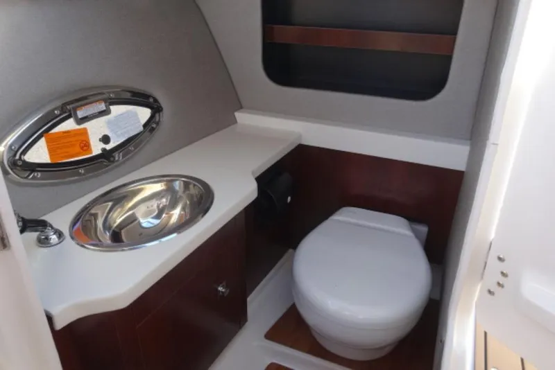 Slide: The Image of 2026 Chaparral 30 Surf boat bathroom with sink and toilet. - 21
