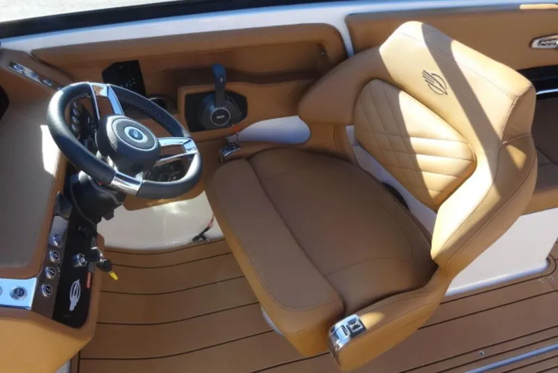 Slide: The Image of 2026 Chaparral 30 Surf boat interior with tan leather seating and modern steering wheel. - 22