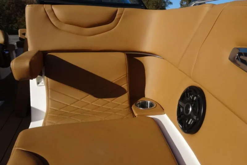 Slide: The Image of 2026 Chaparral 30 Surf boat interior with tan leather seating and speaker. - 25