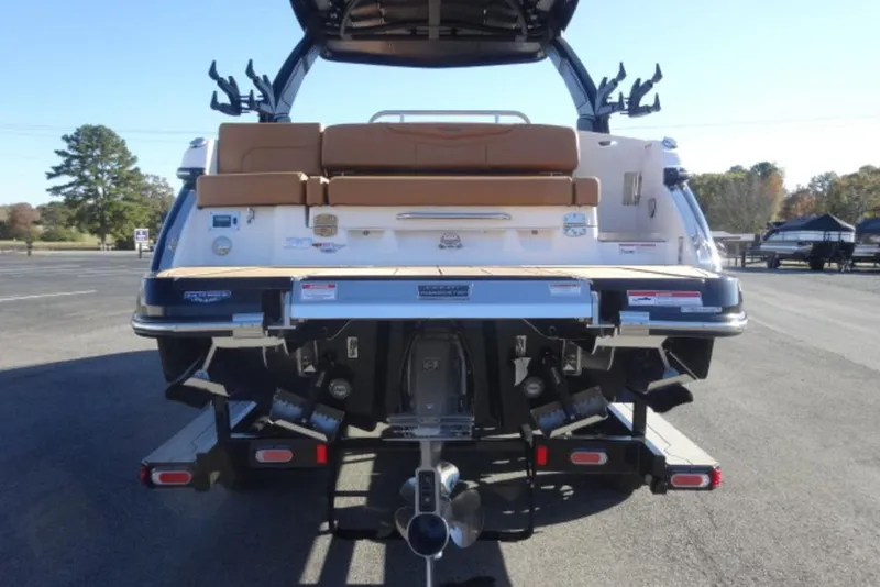 Slide: The Image of 2026 Chaparral 30 Surf boat rear view with seating and outboard motor. - 5