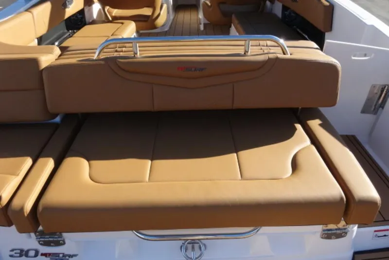 Slide: The Image of 2026 Chaparral 30 Surf boat with tan leather seating and sleek design. - 8