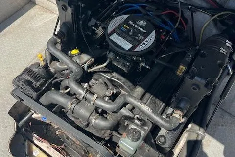 Slide: The Image of Engine of a 2008 Bayliner 215 Discovery boat, showcasing mechanical components. - 10