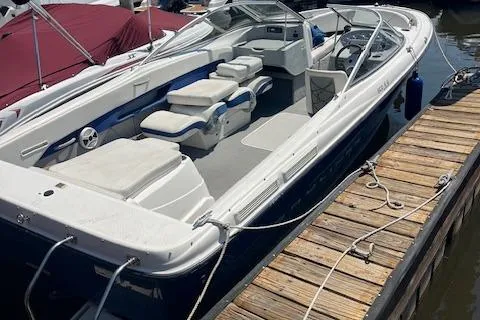 Slide: The Image of 2008 Bayliner 215 Discovery boat docked, featuring spacious seating and sleek design. - 3