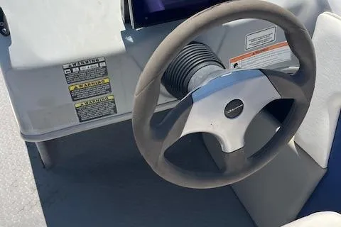 Slide: The Image of 2008 Bayliner 215 Discovery boat steering wheel and dashboard with warning labels. - 4