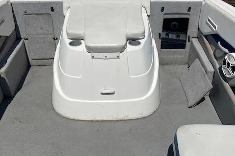 Slide: The Image of 2008 Bayliner 215 Discovery boat interior with seating and storage compartments. - 8