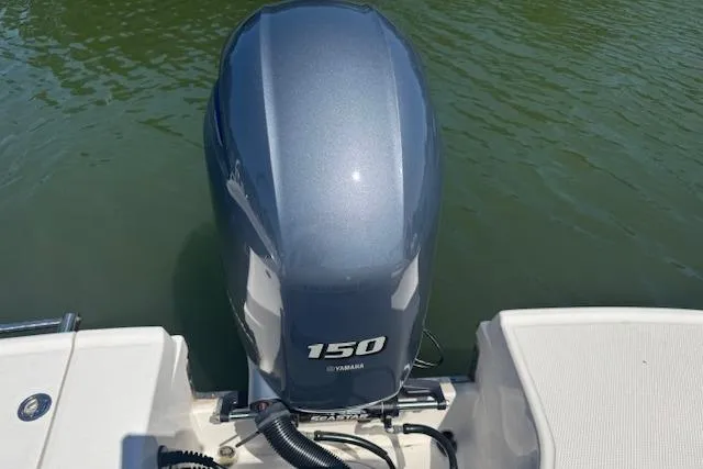 Slide: The Image of 2019 Robalo R207 Dual Console with Yamaha 150 outboard engine on water. - 10