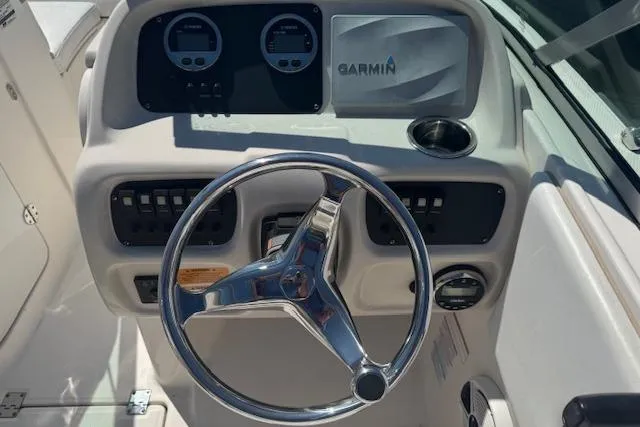 Slide: The Image of 2019 Robalo R207 Dual Console boat dashboard with Garmin navigation system and steering wheel. - 12