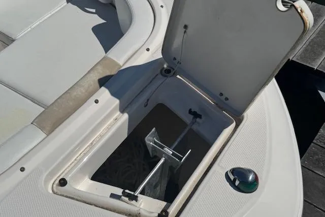 Slide: The Image of 2019 Robalo R207 Dual Console anchor storage compartment open on deck. - 20