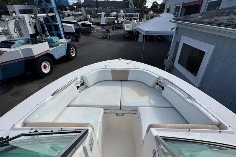 Slide: The Image of 2019 Robalo R207 Dual Console boat with spacious seating in a marina setting. - 24