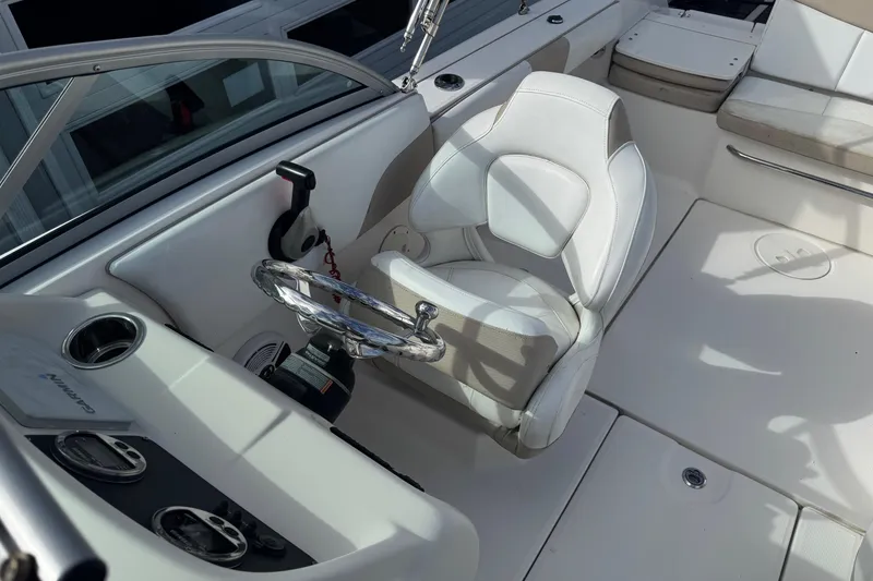 Slide: The Image of 2019 Robalo R207 Dual Console boat interior with steering wheel and seating. - 27