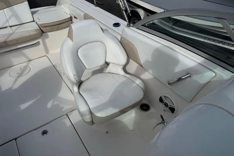Slide: The Image of 2019 Robalo R207 Dual Console boat interior with white seating and cup holder. - 28