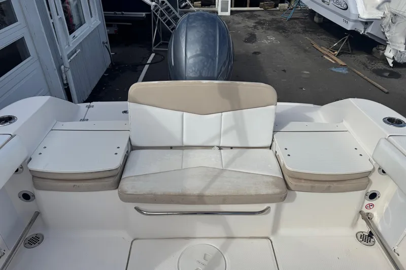 Slide: The Image of 2019 Robalo R207 Dual Console boat interior with beige seating and storage compartments. - 29