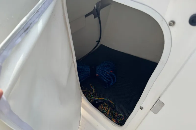 Slide: The Image of Storage compartment in 2019 Robalo R207 Dual Console boat with ropes inside. - 33