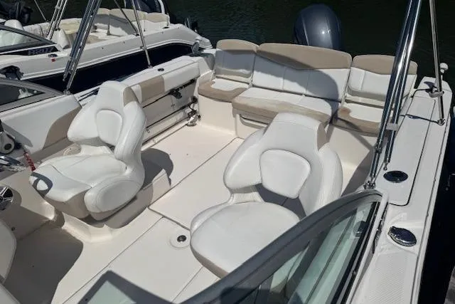 Slide: The Image of 2019 Robalo R207 Dual Console boat interior with white seating and spacious layout. - 4