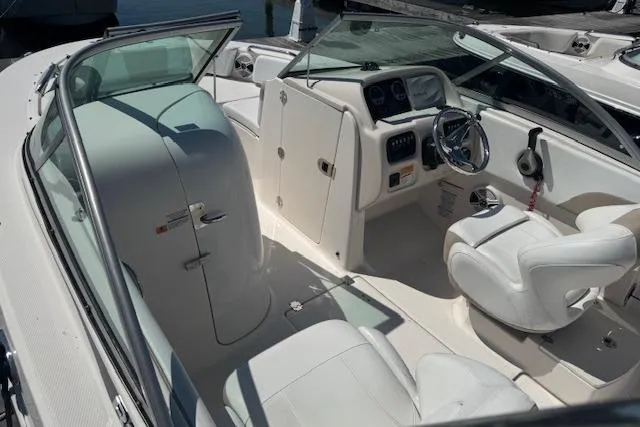 Slide: The Image of 2019 Robalo R207 Dual Console boat interior with white seating and dashboard. - 6