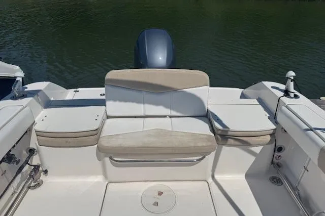 Slide: The Image of 2019 Robalo R207 Dual Console boat interior with seating and motor, on calm water. - 7