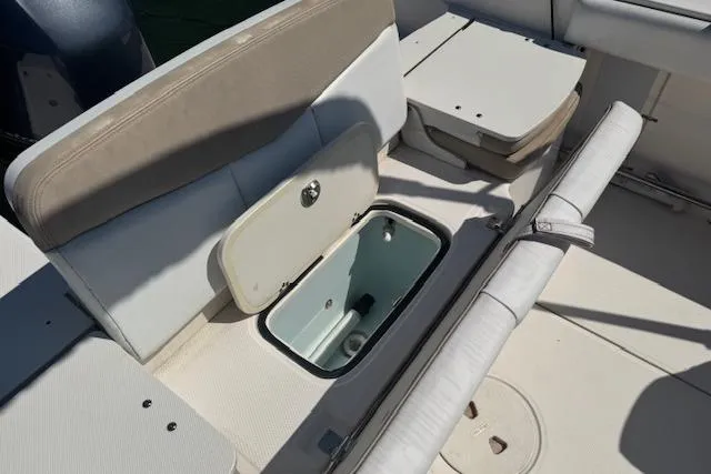 Slide: The Image of 2019 Robalo R207 Dual Console boat interior with open storage compartment. - 8