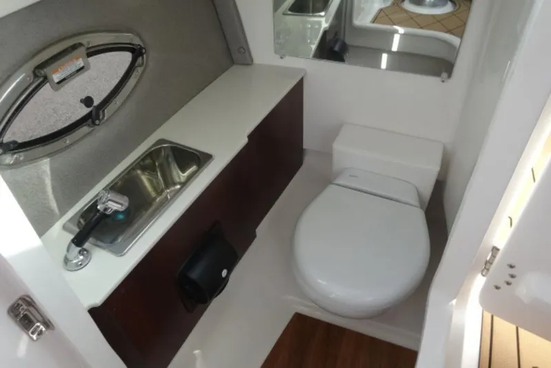 Slide: The Image of 2026 Chaparral 6 GTS boat bathroom with sink and toilet, modern design. - 15