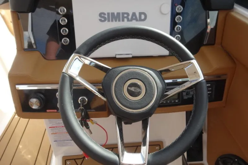 Slide: The Image of Steering wheel of 2026 Chaparral 6 GTS boat with Simrad display. - 17