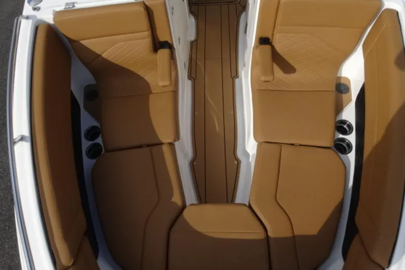Slide: The Image of 2026 Chaparral 6 GTS boat interior with tan seating and cup holders. - 33