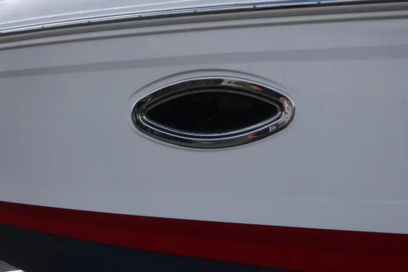 Slide: The Image of 2026 Chaparral 6 GTS boat hull with chrome-trimmed porthole detail. - 37