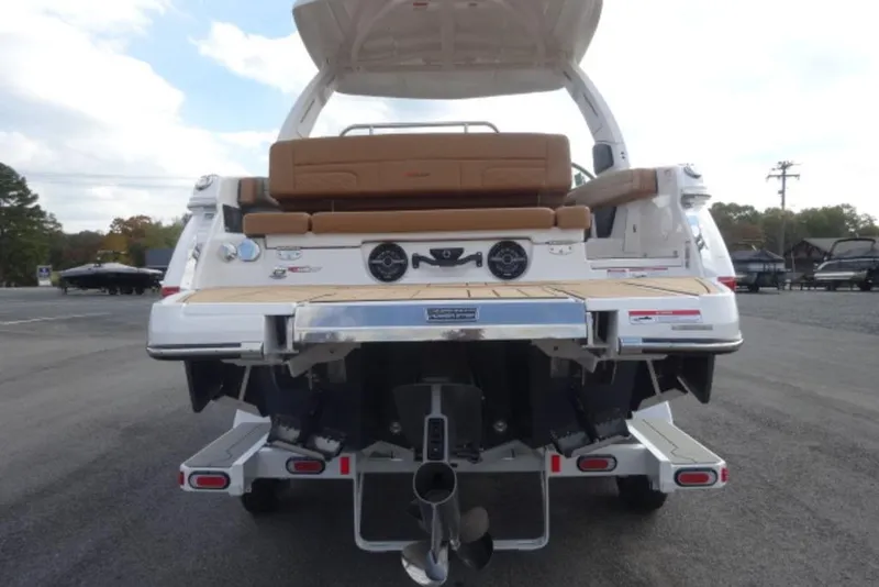 Slide: The Image of 2026 Chaparral 6 GTS boat rear view with open deck and seating. - 4