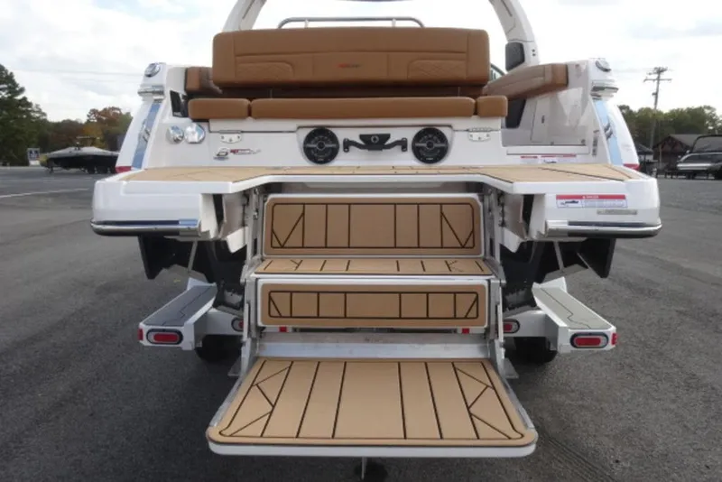 Slide: The Image of 2026 Chaparral 6 GTS boat with extended swim platform and tan seating. - 5