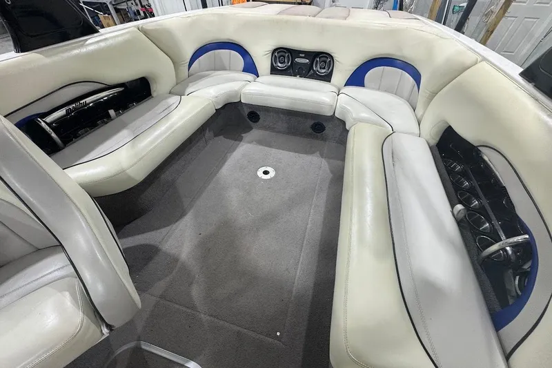 Slide: The Image of 2007 Malibu Wakesetter 23 LSV interior with white and blue seating, carpeted floor. - 10