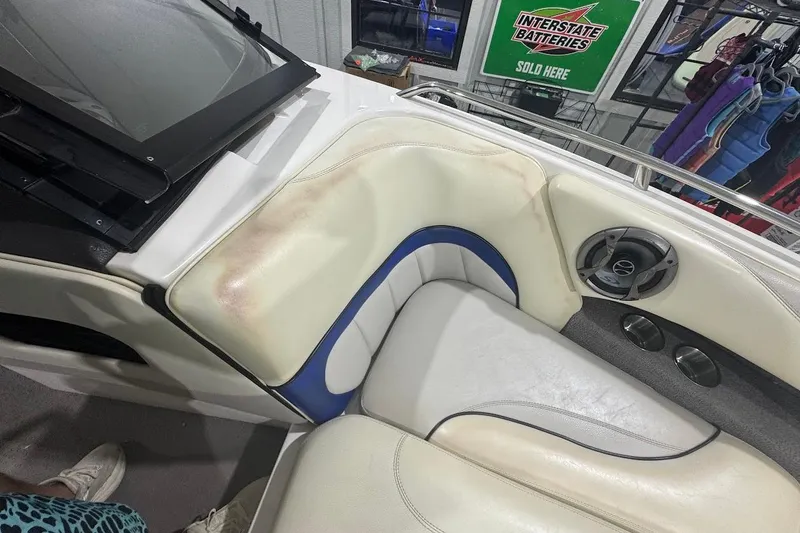 Slide: The Image of 2007 Malibu Wakesetter 23 LSV interior with white and blue seating, speaker, and accessories. - 14