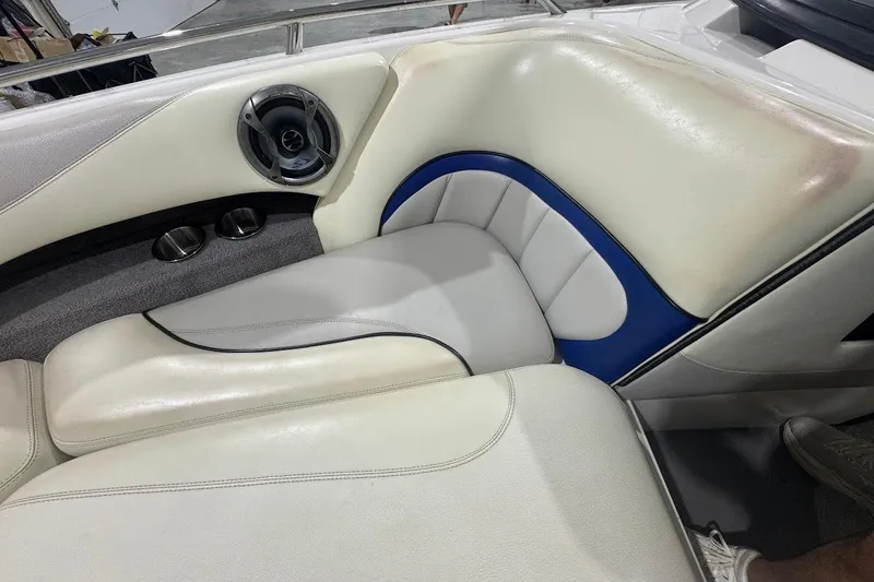 Slide: The Image of 2007 Malibu Wakesetter 23 LSV interior with white and blue seating, speaker, and cup holders. - 15