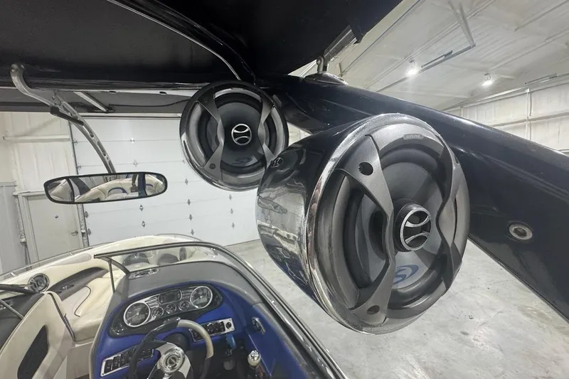 Slide: The Image of 2007 Malibu Wakesetter 23 LSV boat interior with mounted speakers and dashboard view. - 16