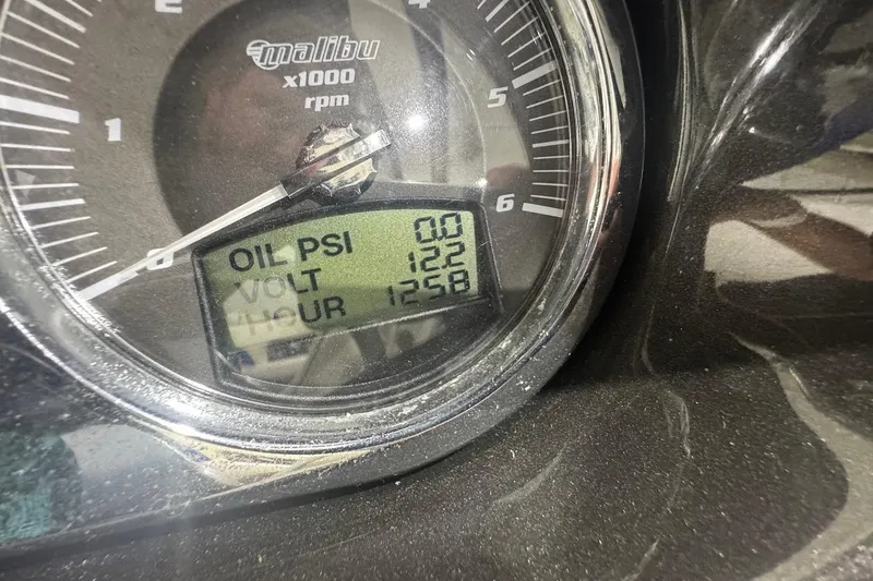 Slide: The Image of Close-up of 2007 Malibu Wakesetter 23 LSV gauge showing oil PSI, voltage, and hours. - 19